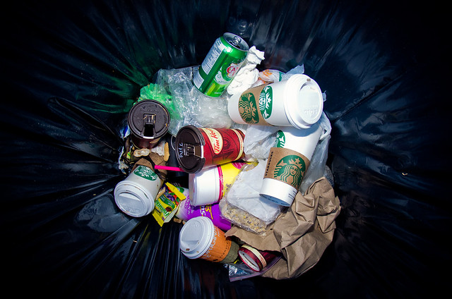 Cups of coffee in trashcan