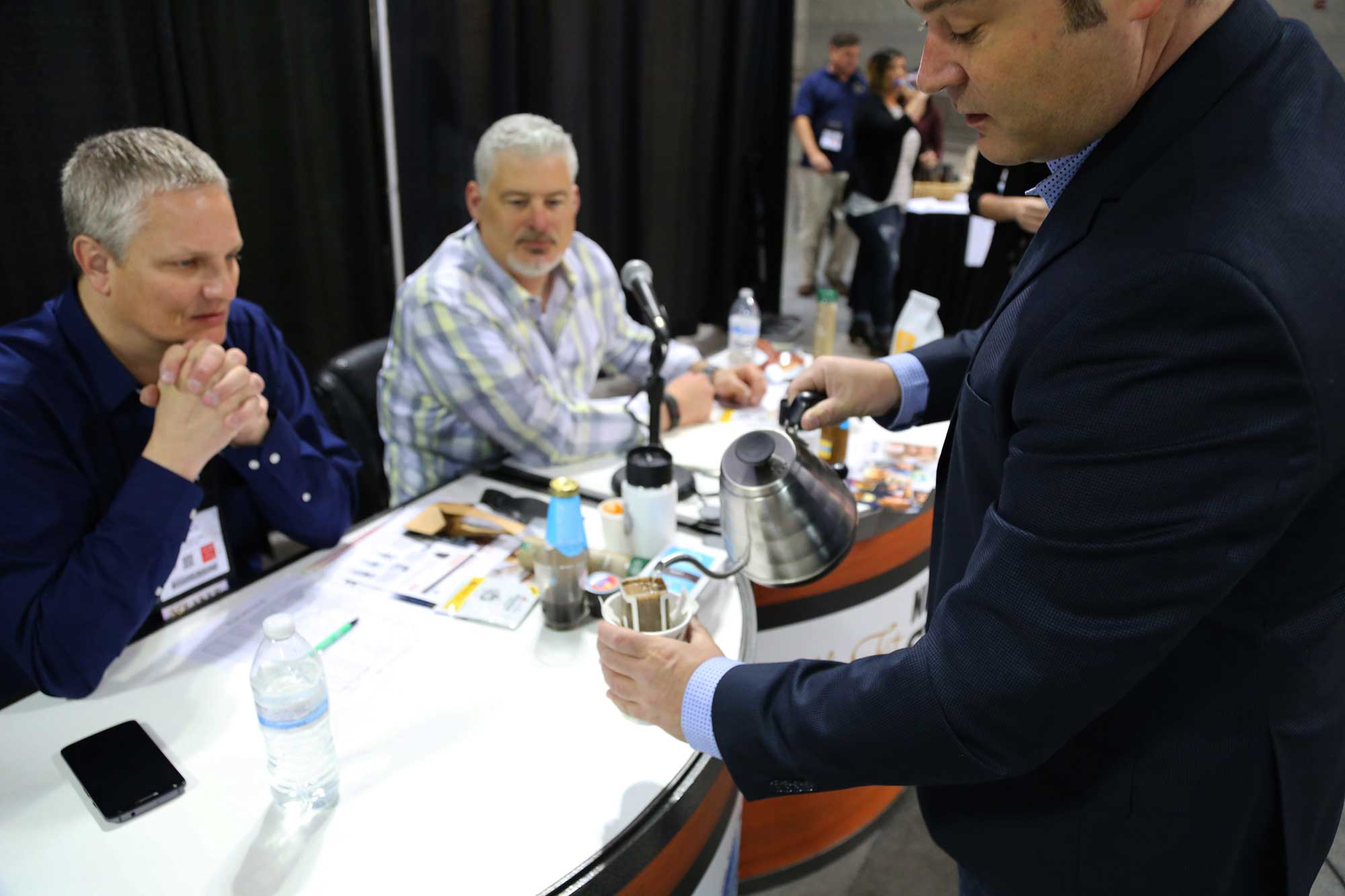 Picture of Mike Spence Judging Best New Product at Coffee Fest